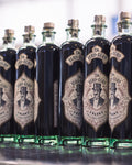Multiple bottles of AmarNo lined up in a row, with labels visible.